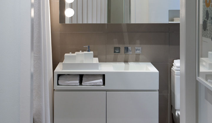 White vanity with ceramic sink and storage by Cartier, Toronto
