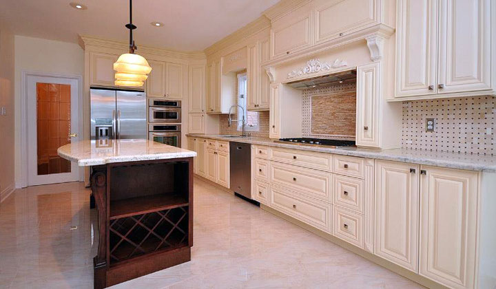 Shutter style white kitchen cabinets by Kitchen & Bath, Thornhill