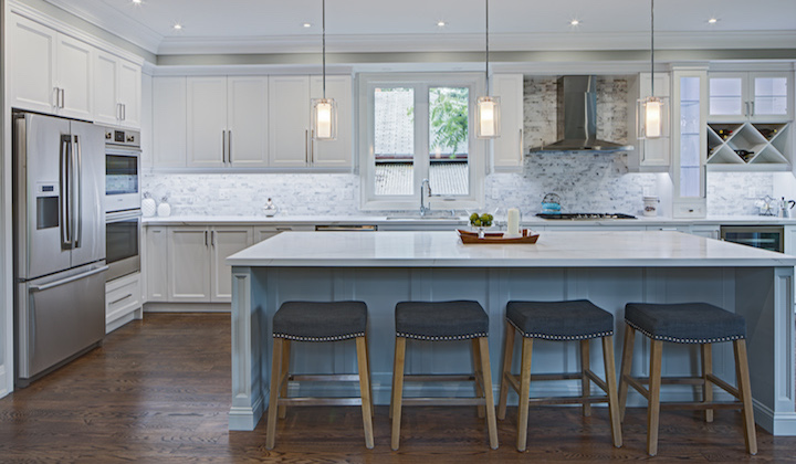 The Symons kitchen design features white kitchen cabinets with Lucvaa's newest colour, Coventry Grey. As with most pictures, the colour looks different here, but it has become a company favourite in the past few months.