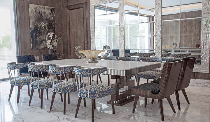 The custom contemporary dining room exhibits a mix of natural wood, marble, and metal detailing.
