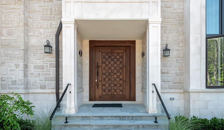 The solid wood door exhibits alternating square patterns which protrude throughout the surface, creating a unique and intricate design.